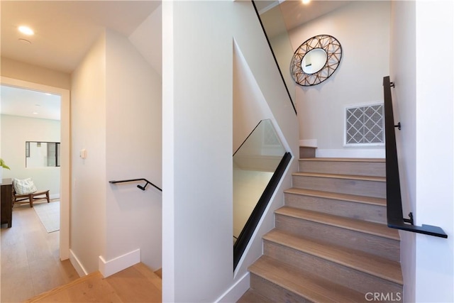 stairway featuring hardwood / wood-style floors