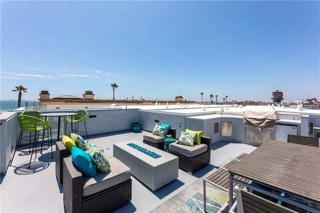 view of patio with an outdoor living space with a fire pit and area for grilling