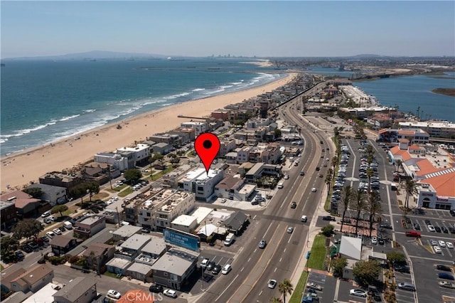 aerial view with a water view and a beach view