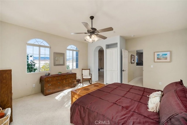 bedroom featuring ceiling fan and light carpet