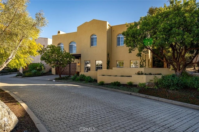 pueblo-style home with a garage