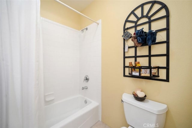 bathroom featuring toilet and shower / tub combo with curtain