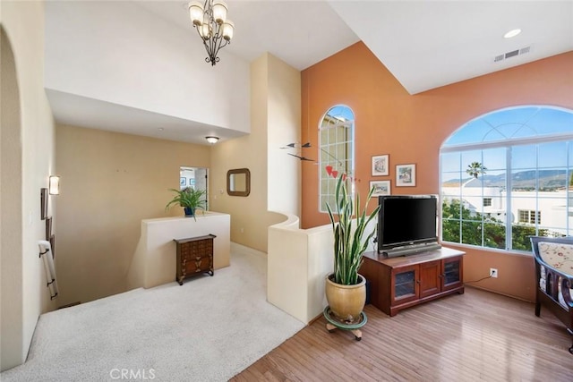 living room with light carpet and a chandelier