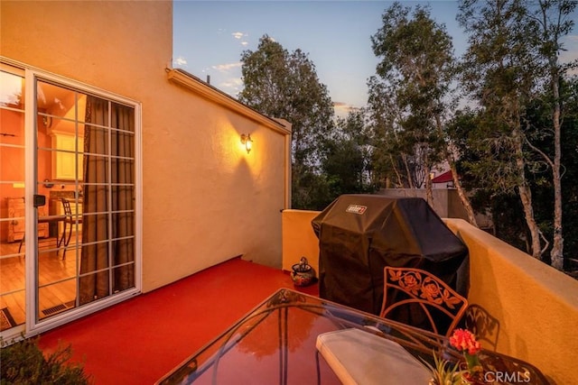 patio terrace at dusk with grilling area and a balcony