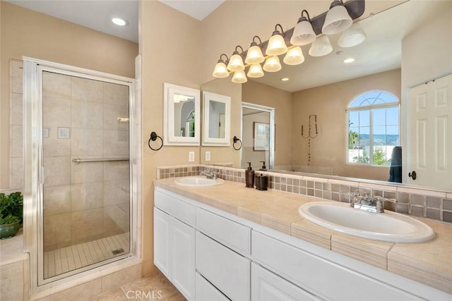 bathroom with decorative backsplash, an enclosed shower, vanity, and tile patterned flooring