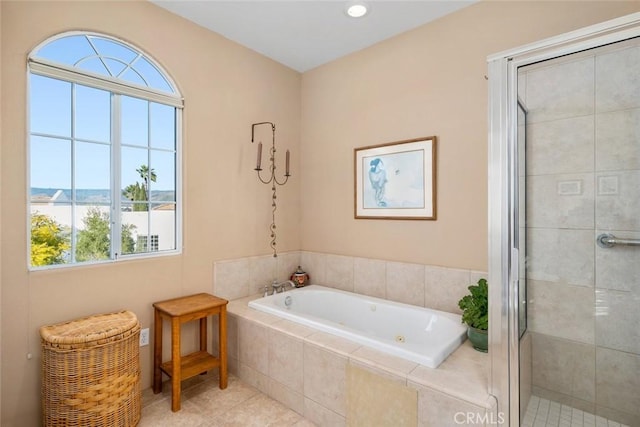 bathroom with separate shower and tub and tile patterned flooring