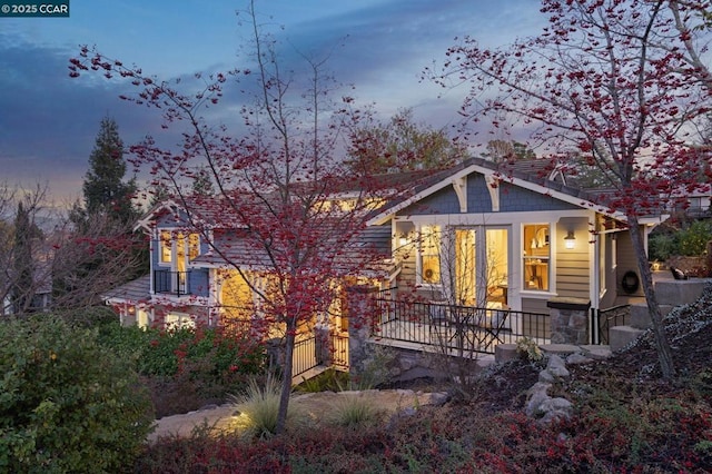 view of back house at dusk