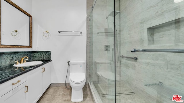 bathroom with backsplash, toilet, vanity, and an enclosed shower