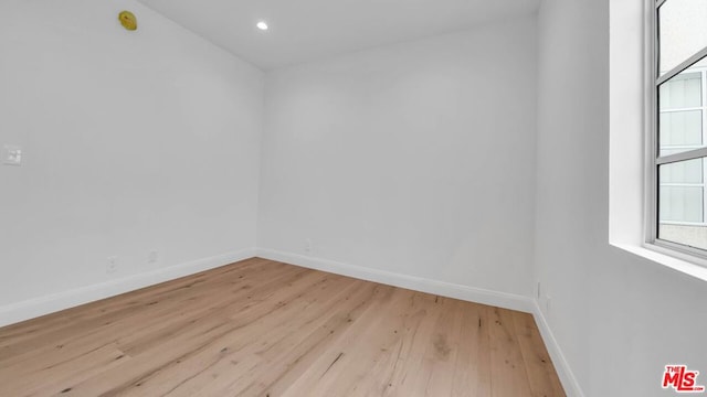 spare room featuring light wood-type flooring