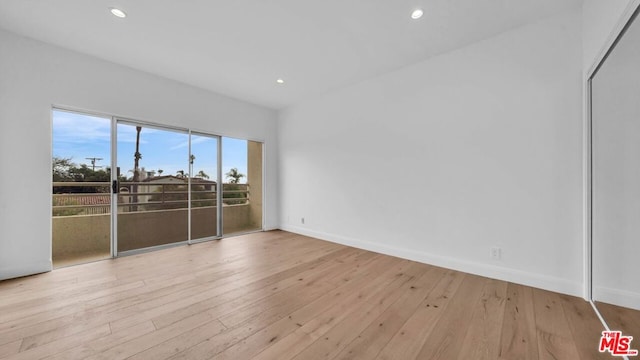 spare room featuring light hardwood / wood-style floors