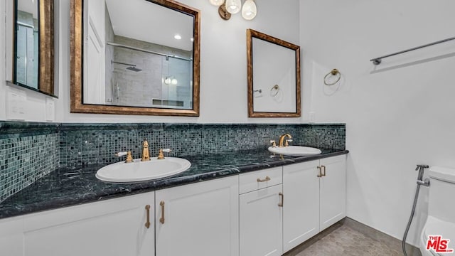 bathroom with vanity, an enclosed shower, decorative backsplash, and tile patterned flooring