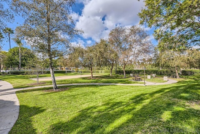 view of property's community featuring a yard and volleyball court