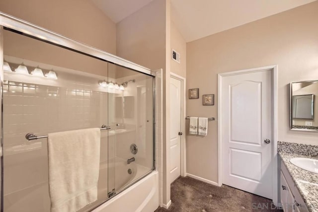 bathroom featuring vanity and shower / bath combination with glass door