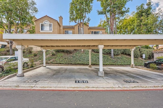 view of vehicle parking with a carport