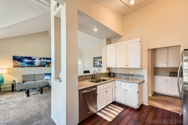 kitchen featuring dark hardwood / wood-style floors, white cabinetry, sink, stainless steel appliances, and light stone countertops