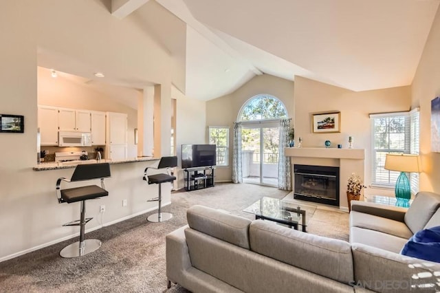 living room featuring light colored carpet and high vaulted ceiling