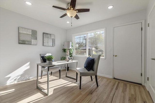 office featuring light hardwood / wood-style floors and ceiling fan