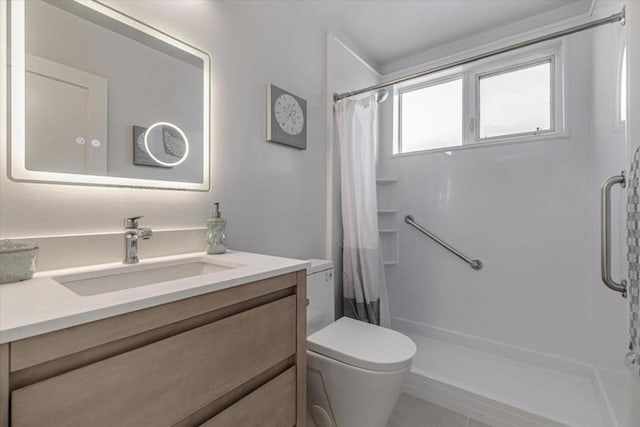 bathroom featuring walk in shower, vanity, tile patterned floors, and toilet