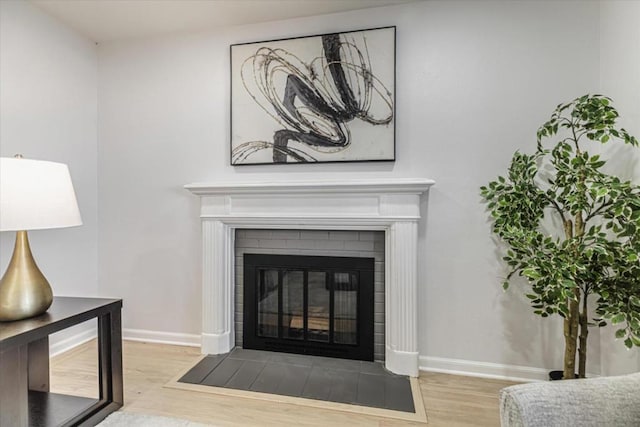 room details with hardwood / wood-style flooring and a fireplace