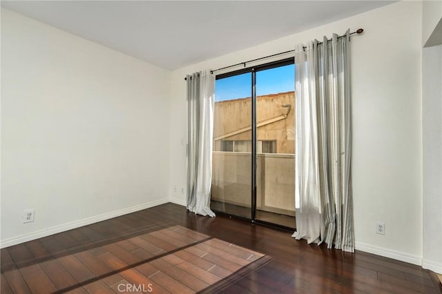 empty room with dark hardwood / wood-style floors