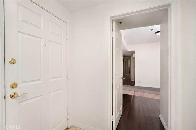 hallway with dark wood-type flooring