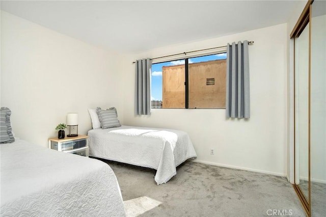 carpeted bedroom featuring a closet