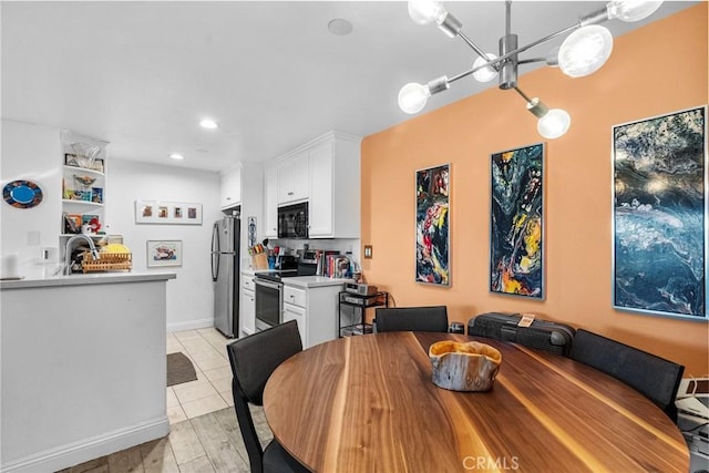 dining space with sink and light hardwood / wood-style flooring