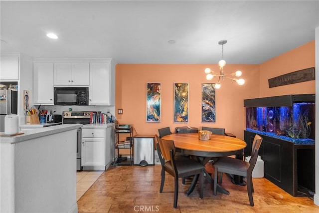 dining area with light tile patterned floors and a chandelier