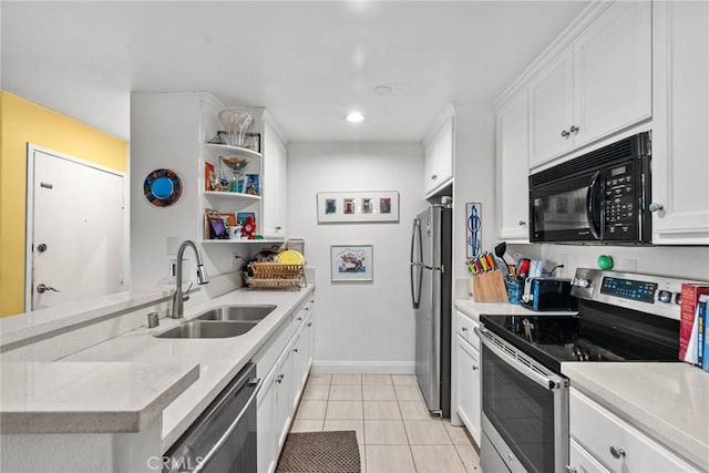 kitchen featuring white cabinetry, kitchen peninsula, stainless steel appliances, light tile patterned flooring, and sink