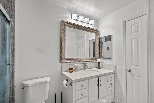 bathroom featuring toilet and vanity