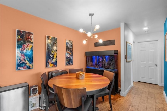 dining room featuring light hardwood / wood-style flooring and a notable chandelier