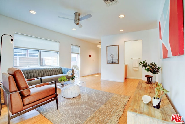 living room featuring ceiling fan and light wood-type flooring