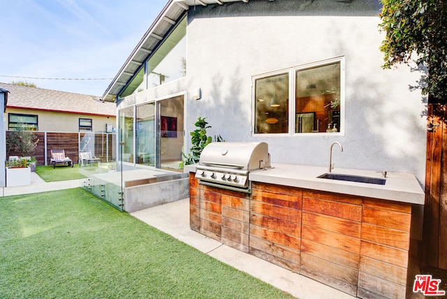 view of patio / terrace with grilling area, exterior kitchen, and sink