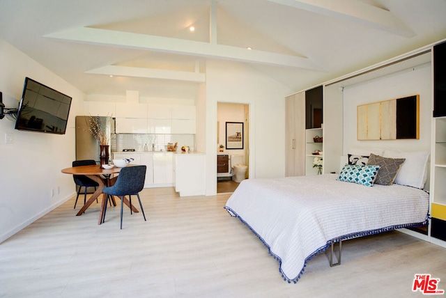 bedroom with ensuite bath, lofted ceiling with beams, and light hardwood / wood-style floors