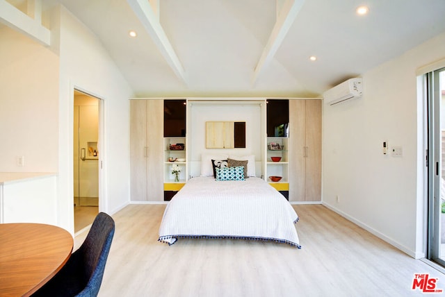 bedroom with vaulted ceiling, an AC wall unit, and light hardwood / wood-style flooring