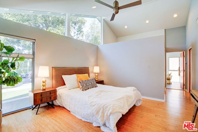 bedroom featuring high vaulted ceiling, access to exterior, ceiling fan, and light hardwood / wood-style floors