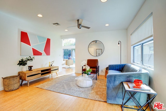 living room with hardwood / wood-style flooring and ceiling fan