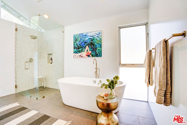 bathroom with lofted ceiling, tile patterned flooring, and plus walk in shower