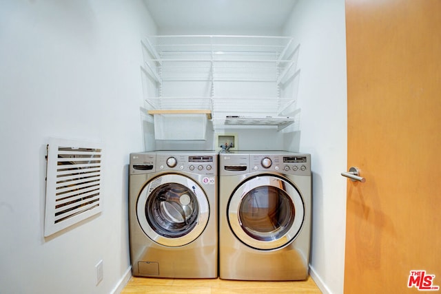 washroom featuring separate washer and dryer and light hardwood / wood-style floors