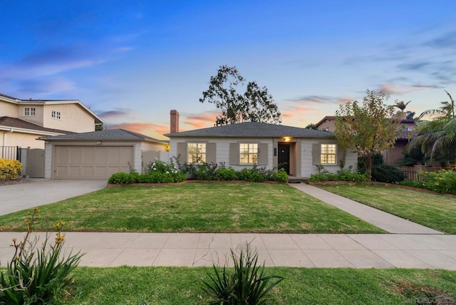 view of front of property with a lawn and a garage