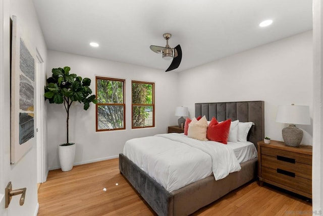 bedroom with ceiling fan and light hardwood / wood-style floors