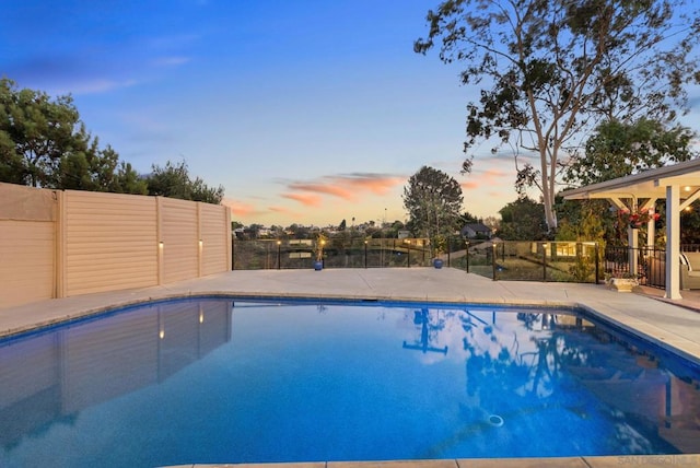 view of pool at dusk