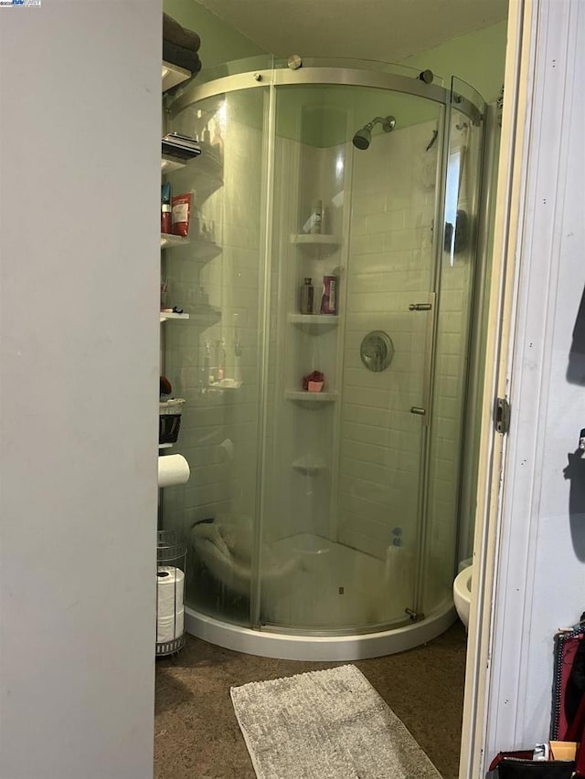 bathroom with a shower with door