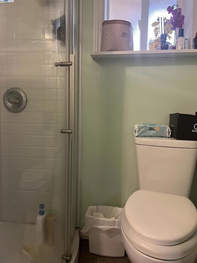 bathroom with an enclosed shower and toilet