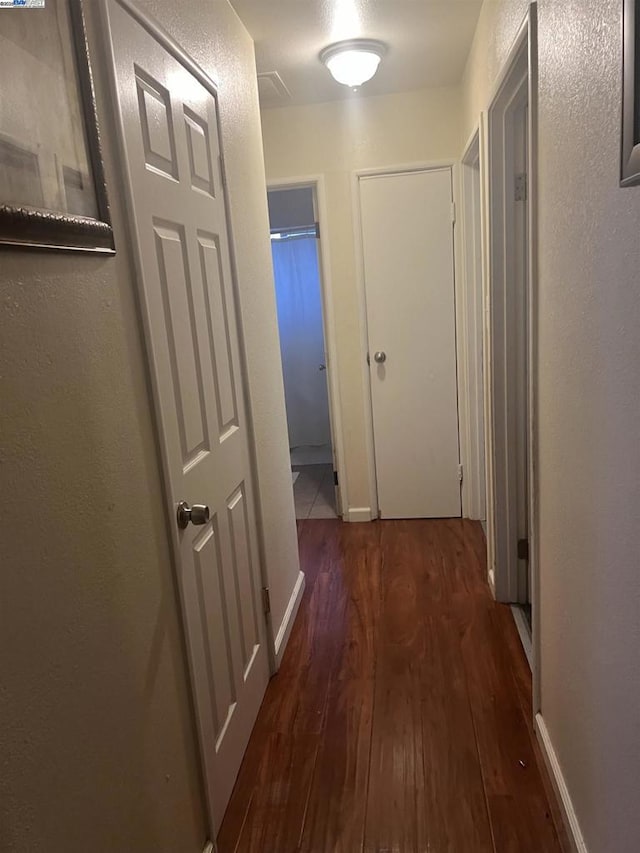 hallway featuring dark hardwood / wood-style floors