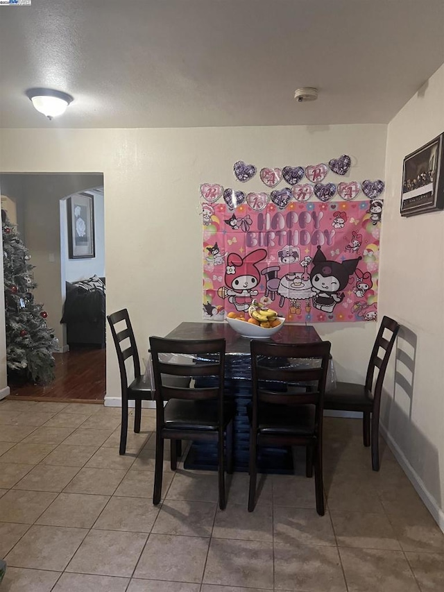 dining space with tile patterned floors