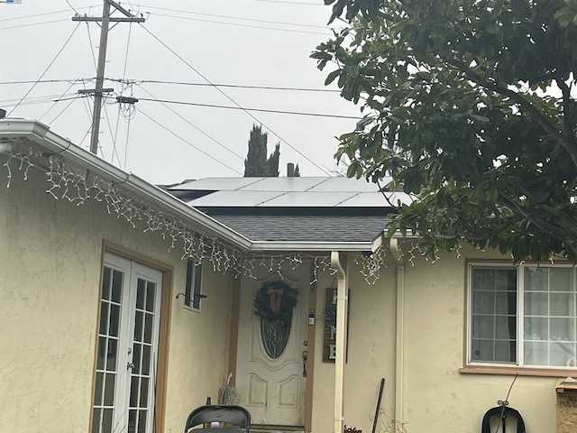 doorway to property featuring solar panels