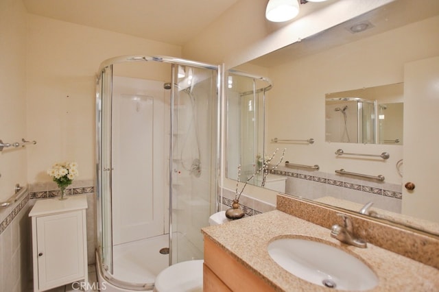 bathroom with backsplash, vanity, and a shower stall