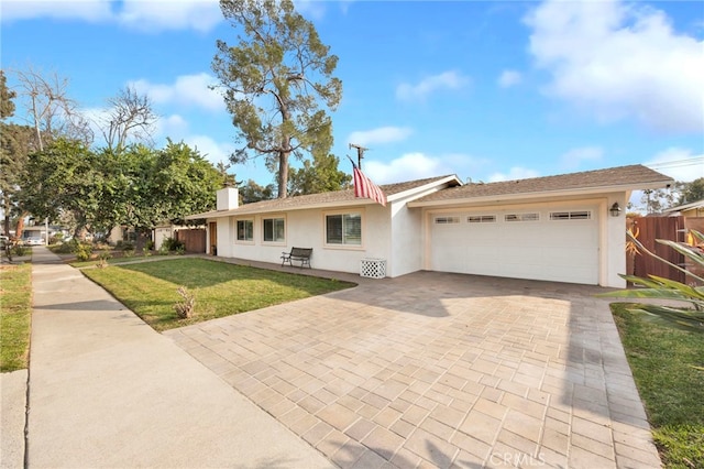 ranch-style house featuring a front yard and a garage