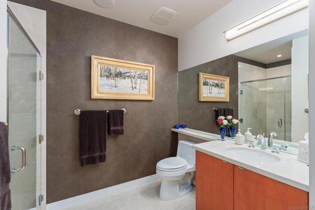 bathroom featuring toilet, a shower with shower door, and vanity